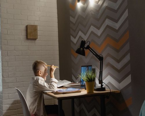 A home study room with subtle table lighting and ambient space layout for online learning
